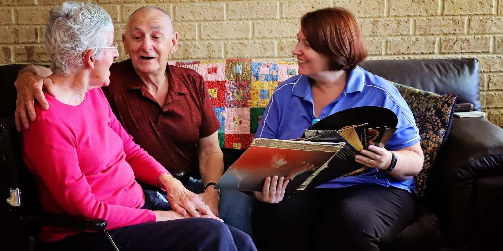 Three people sitting in living room having a discussion.