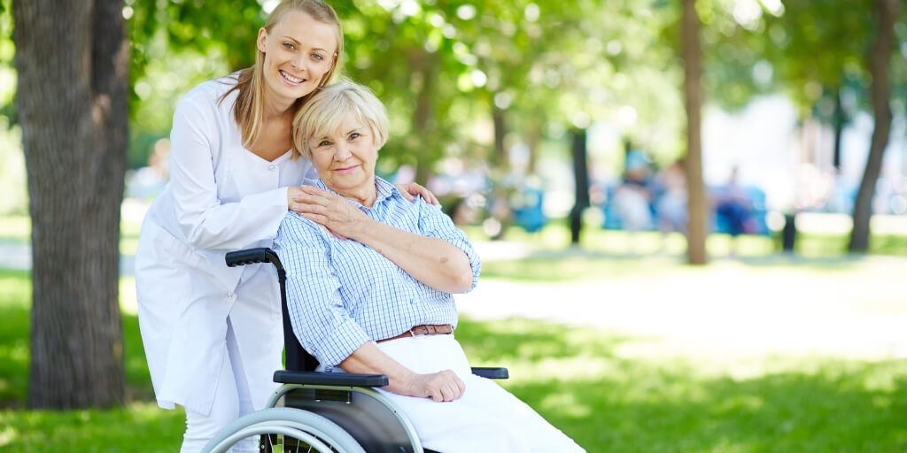 Carer with a client in a wheelchair.