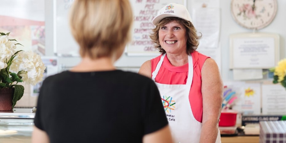 Brightwater staff member working at cafe smiling