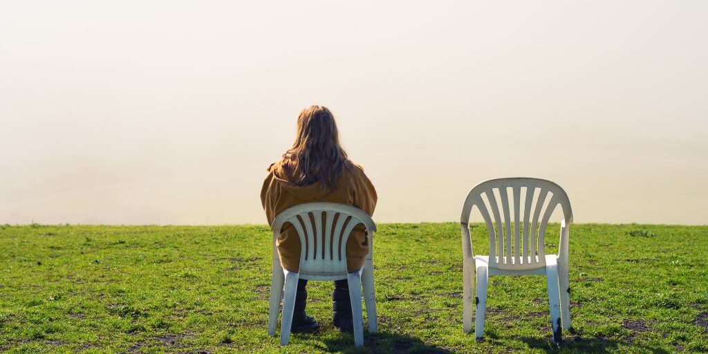 Person sitting alone on chair.