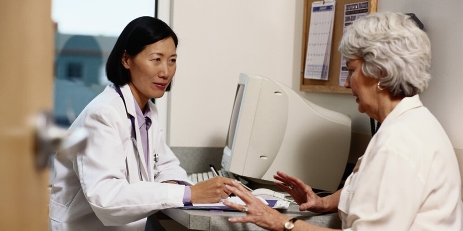 Female doctor with elderly patient