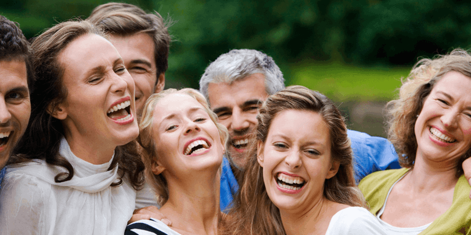 Group of four women and three men laughing