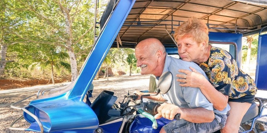 Elderly couple driving a motorbike