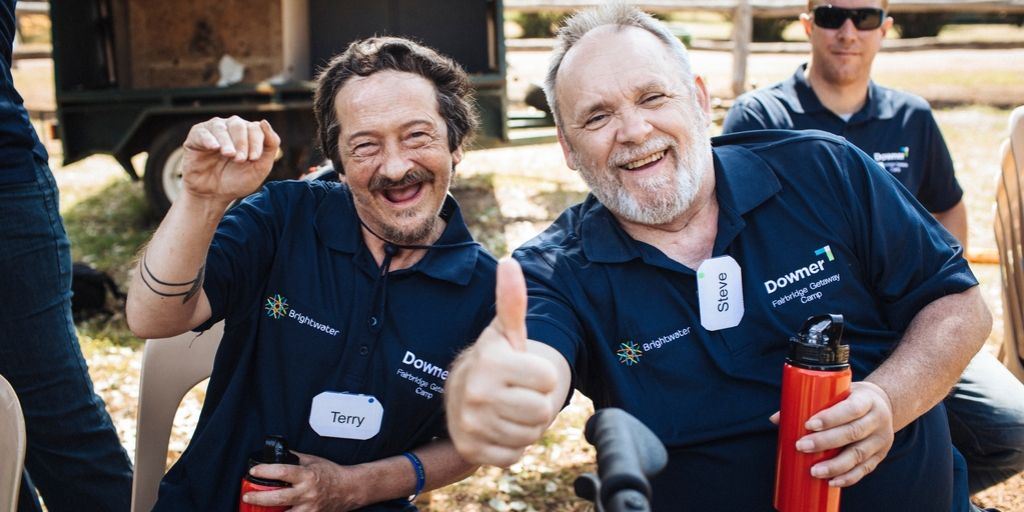 Two people waving at the camera.